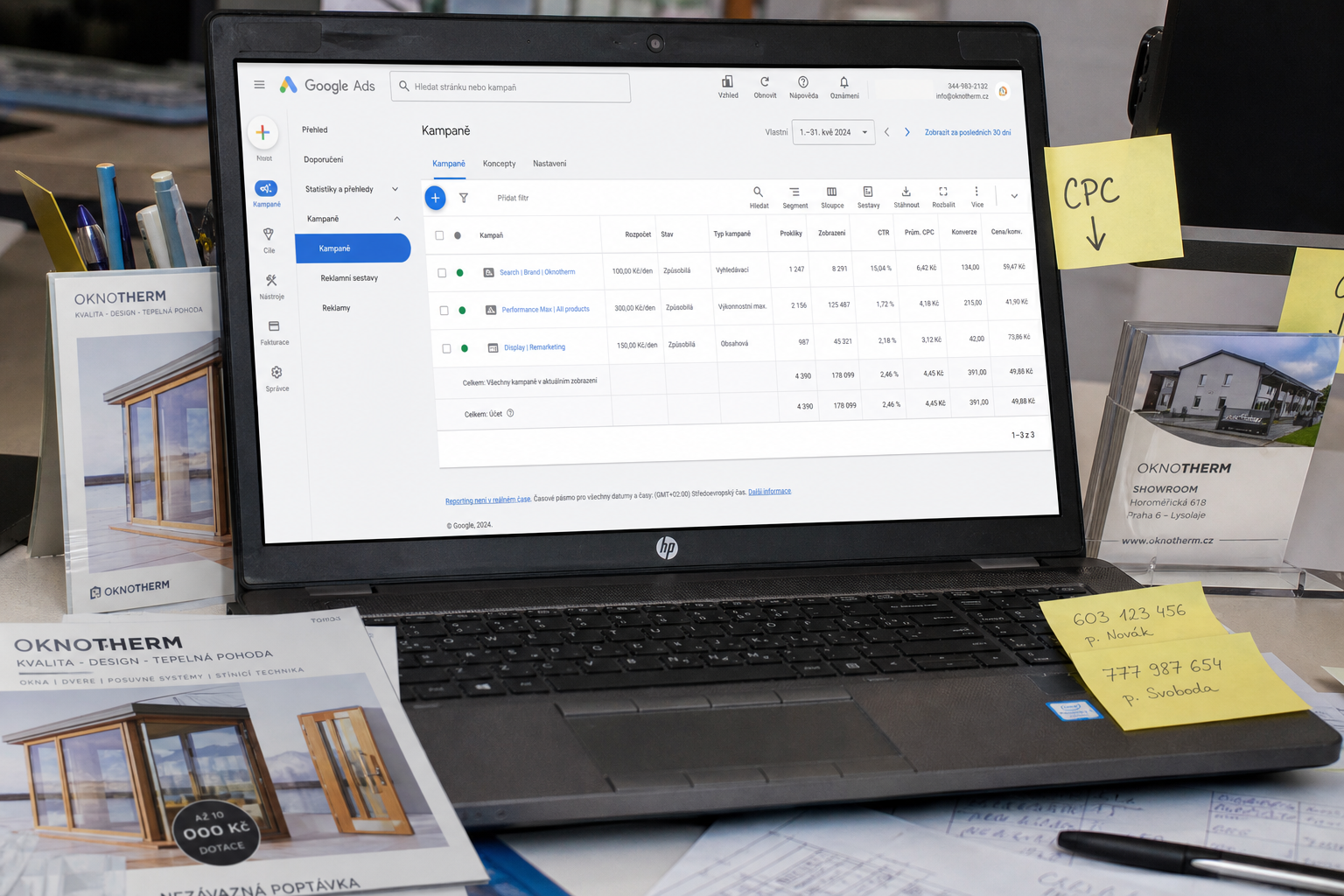HP notebook s Google Ads kampaněmi na stole s letáky